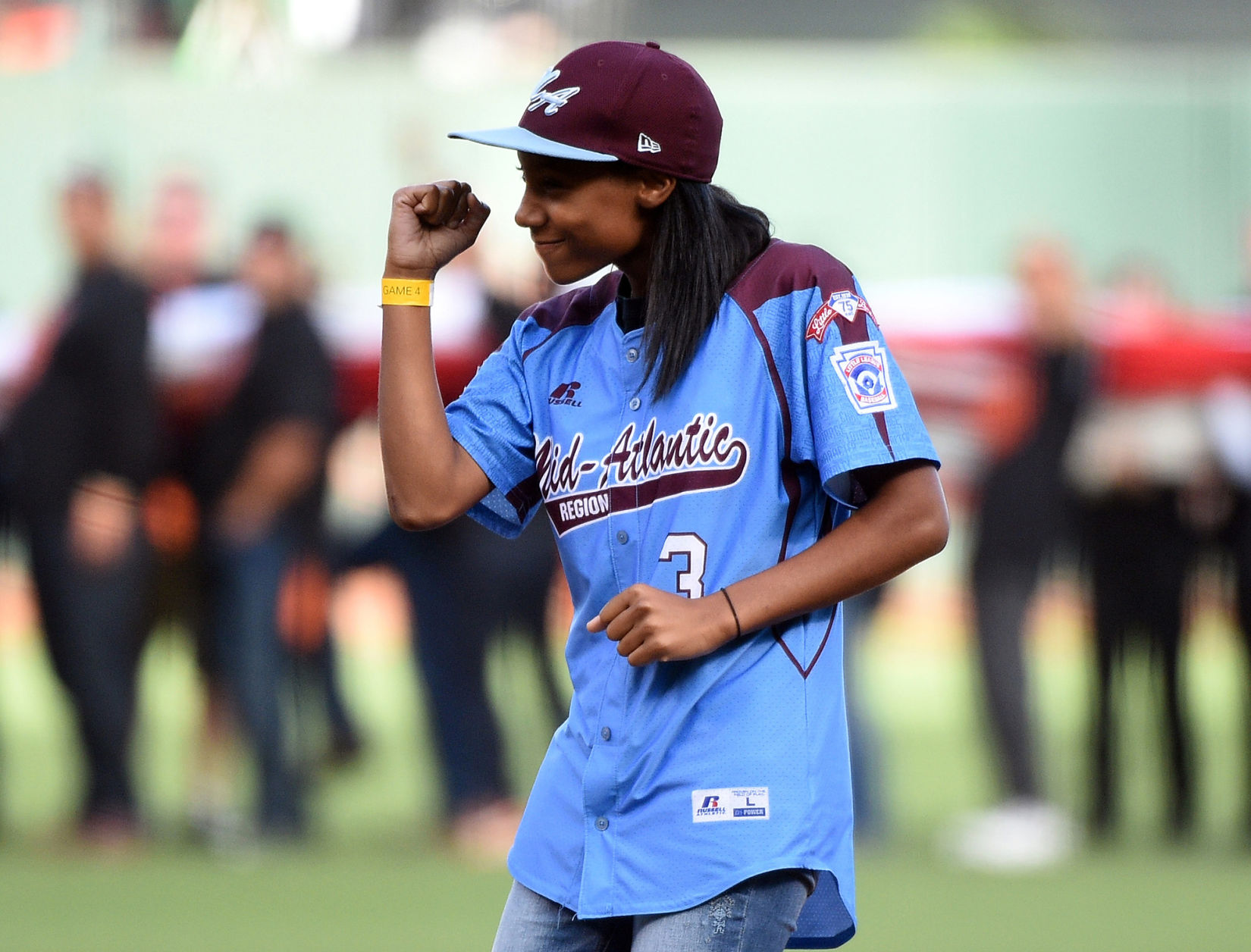 Little League Baseball pitcher Mo'ne Davis reacts after she throws out the ceremonial first pitch before Game 4 of the 2014 World Series at AT&T Park in San Francisco on October 25, 2014. **FOR USE WITH THIS STORY ONLY**